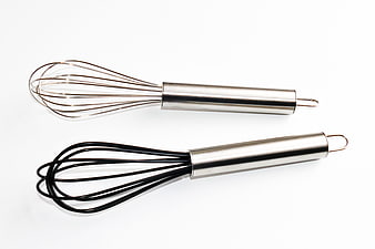 Two stainless steel kitchen whisks on white background