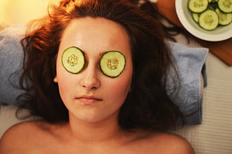 Woman Relaxing with Cucumber Slices on Eyes for Spa Treatment