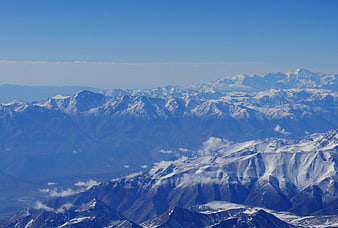 Snow-Capped Mountain Range Under Clear Blue Sky
