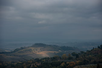 Moody Tuscany Landscape with Rolling Hills and Overcast Sky