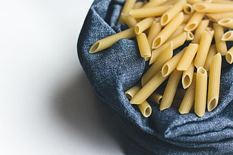 Uncooked Penne Pasta in Blue Linen Cloth