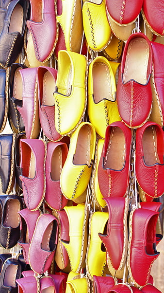 Colorful leather espadrilles hanging in a market display