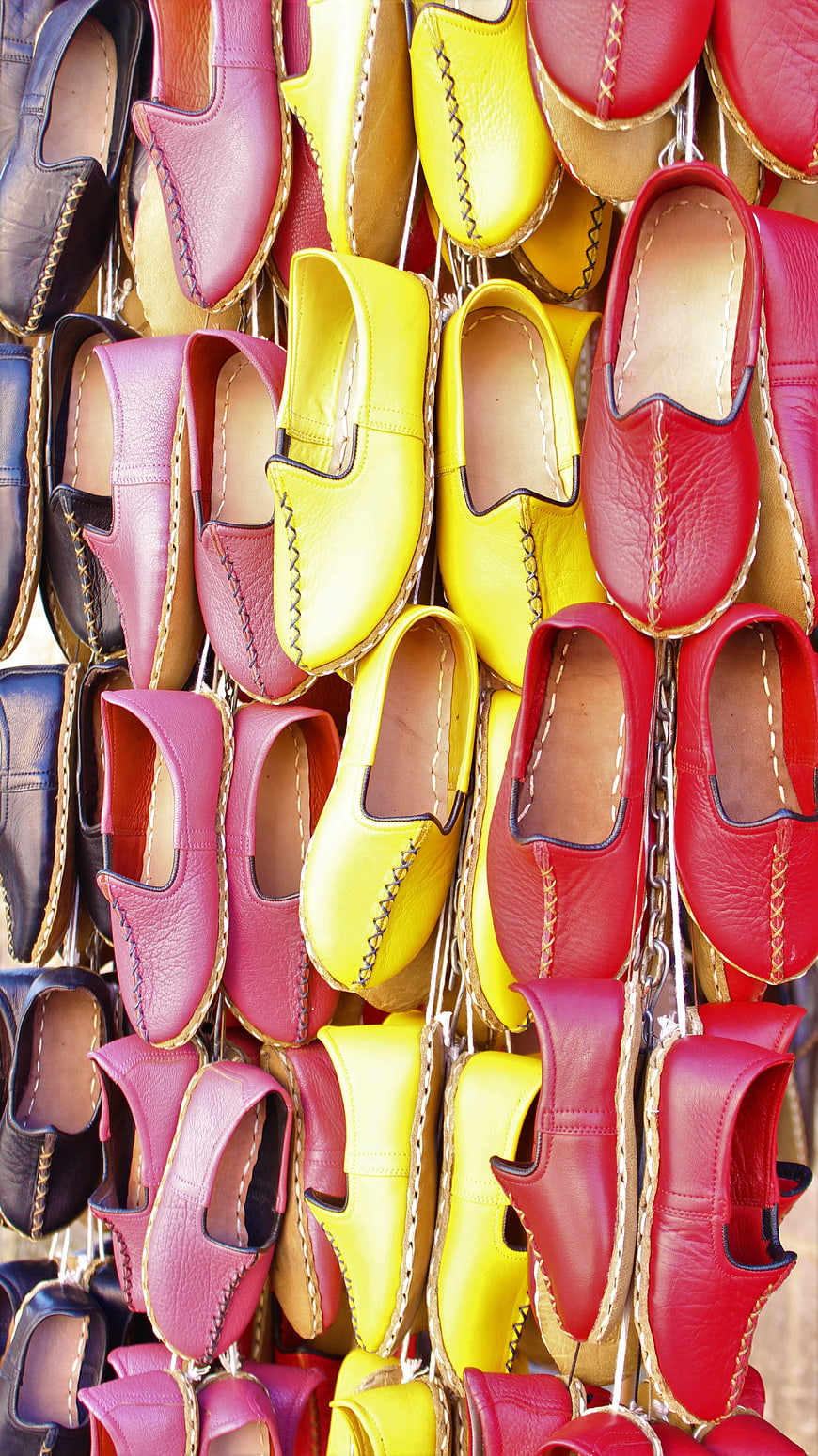 Colorful leather espadrilles hanging in a market display