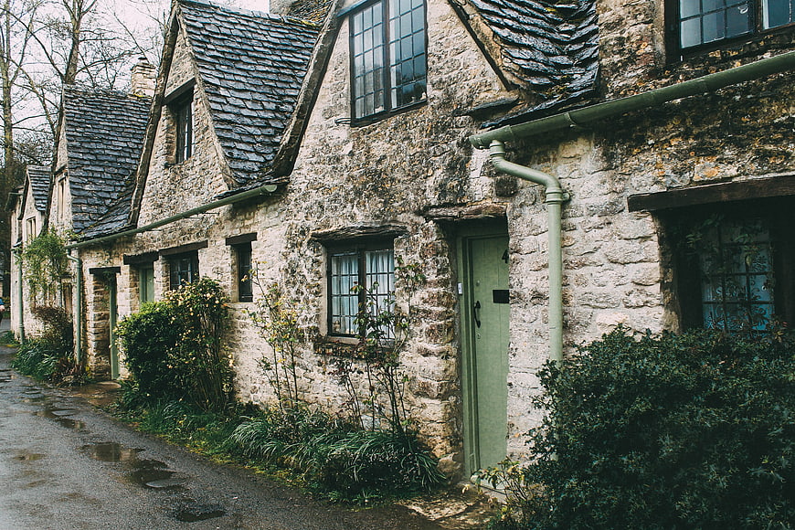 Old Stone Cottages with Slate Roofs on a Wet Street