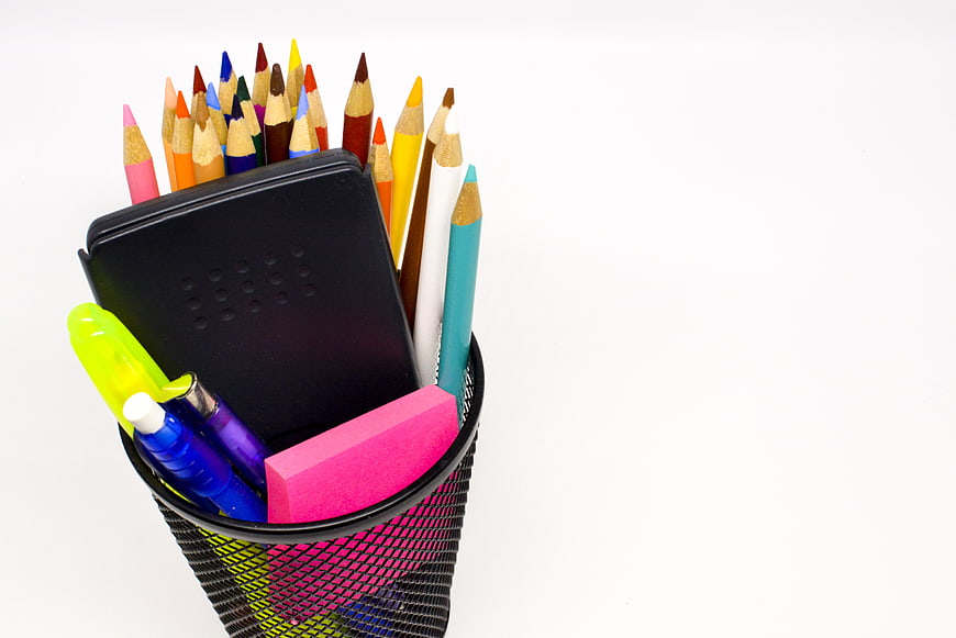 Colorful School Supplies in Mesh Pencil Holder on White Background