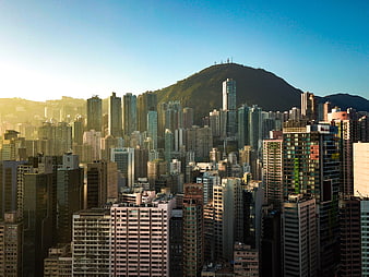 Hong Kong Cityscape with Skyscrapers and Mountain at Golden Hour