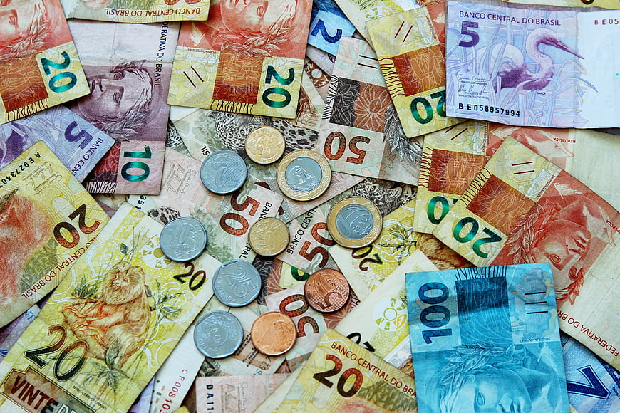 Scattered Brazilian Real Banknotes and Coins Flat Lay