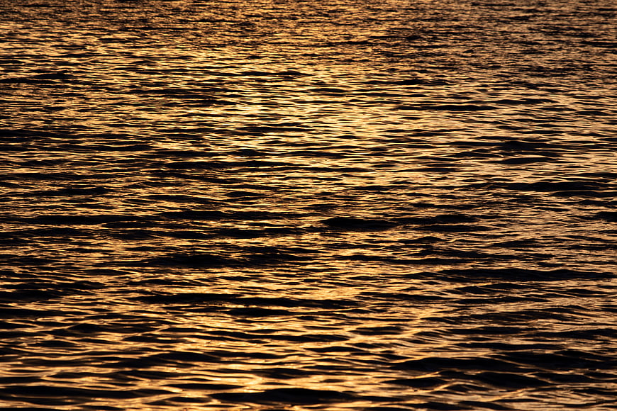 Golden Sunset Reflections on Rippled Water Surface