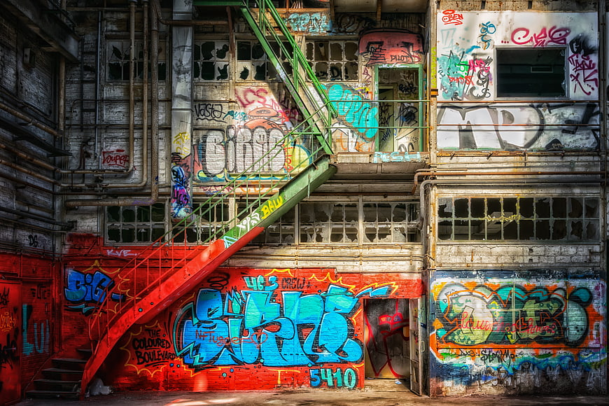 Abandoned Factory Facade Covered In Colorful Urban Graffiti Art