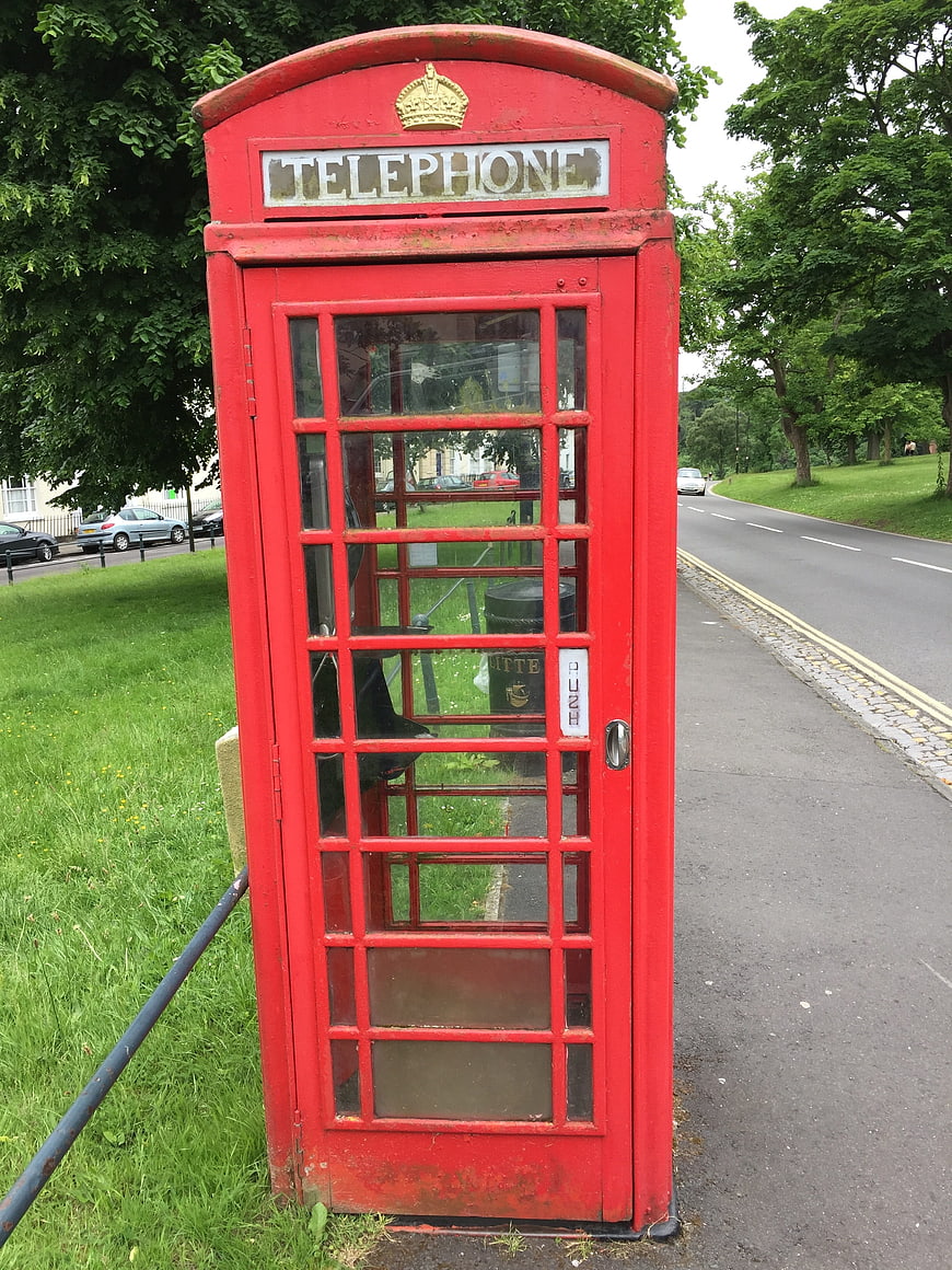 Classic Red British Telephone Box on Green Grass