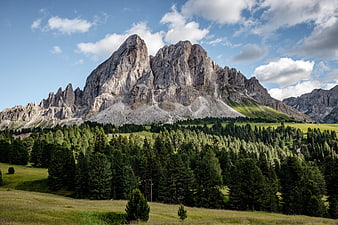 Majestic Dolomites Mountain Landscape with Green Forest and Blue Sky