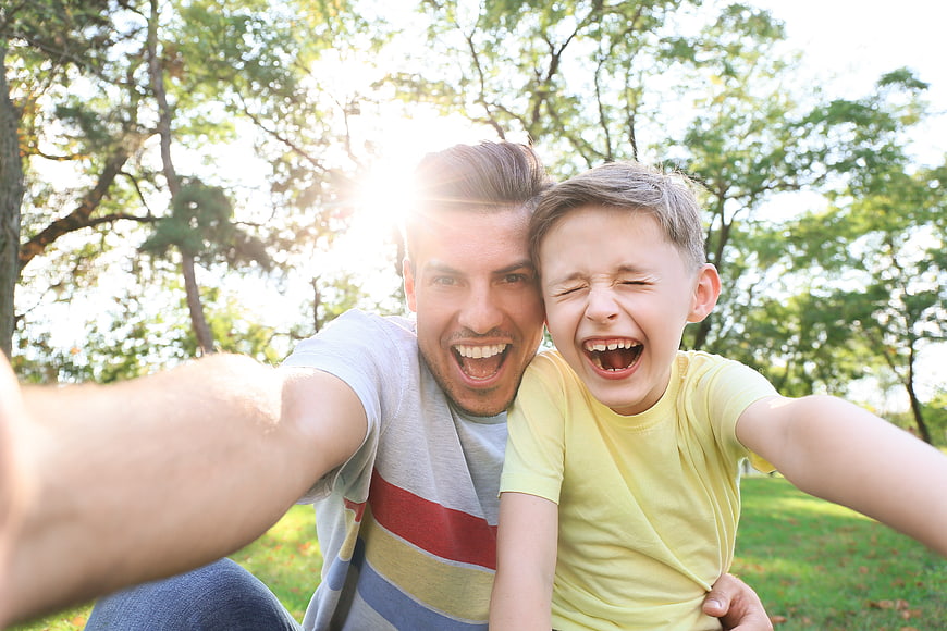 Happy Father and Son Taking Selfie in Park