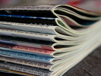 Close-up of stacked magazines with visible spine text
