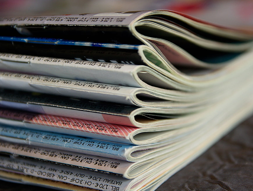Close-up of stacked magazines with visible spine text