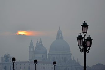 Foggy Venice skyline with Basilica di Santa Maria della Salute at sunset