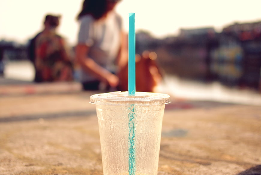 Cold Iced Drink in Plastic Cup with Blue Straw
