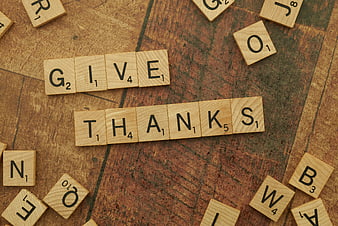 Wooden Scrabble Tiles Spelling Give Thanks on Rustic Wood