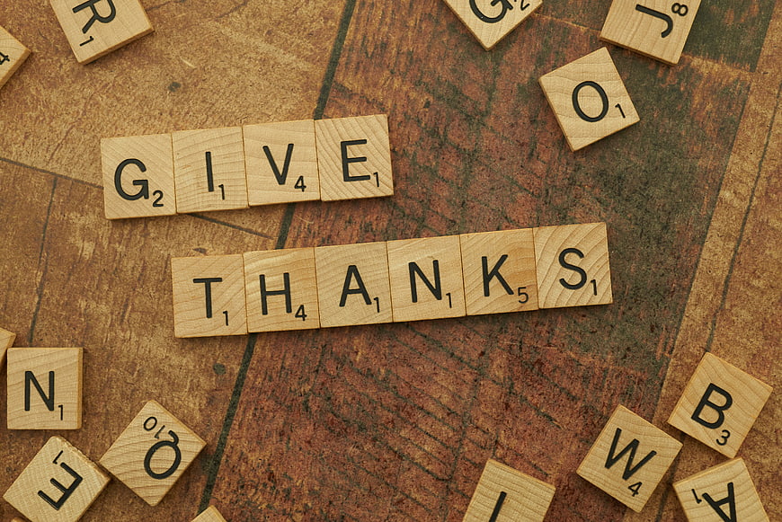 Wooden Scrabble Tiles Spelling Give Thanks on Rustic Wood