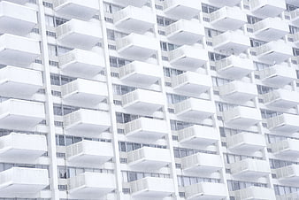 White apartment building facade with repeating balconies