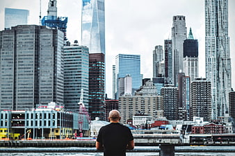 Man Looking at New York City Skyline from Waterfront