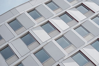 Modern white building facade with geometric window pattern