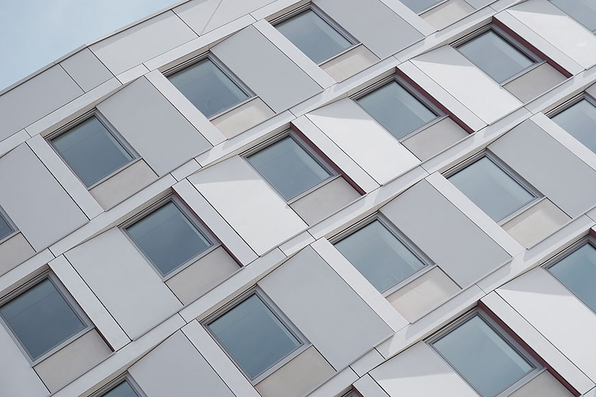 Modern white building facade with geometric window pattern