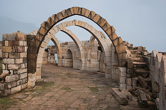 Ancient stone arches at Champaner-Pavagadh archaeological site ruins