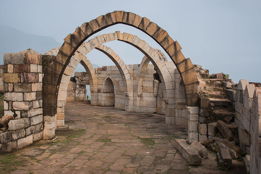 Ancient stone arches at Champaner-Pavagadh archaeological site ruins