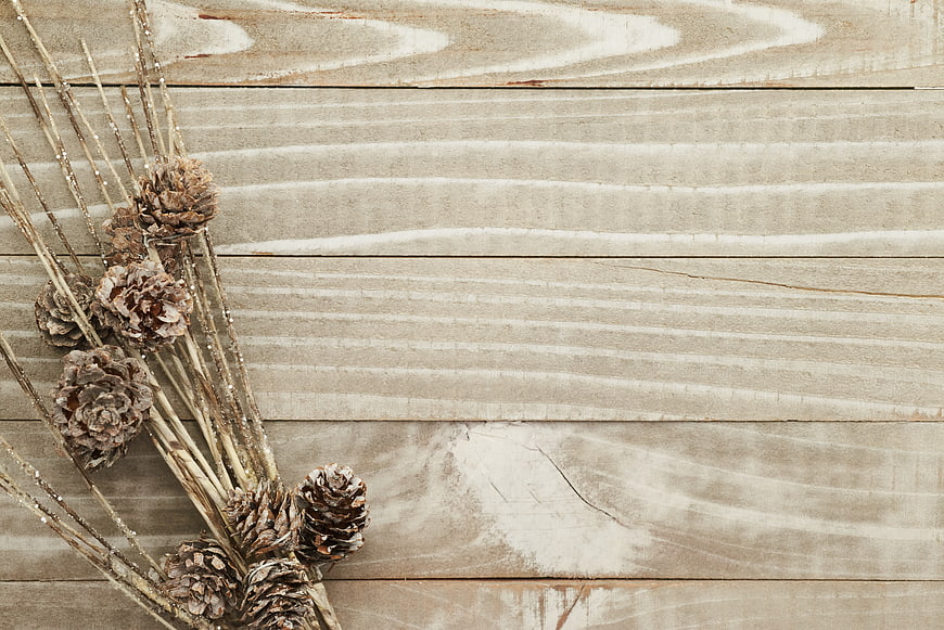 Rustic Pine Cones and Glitter Sticks on Wooden Background