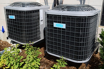 Two KeepRite HVAC outdoor condenser units installed on a residential foundation