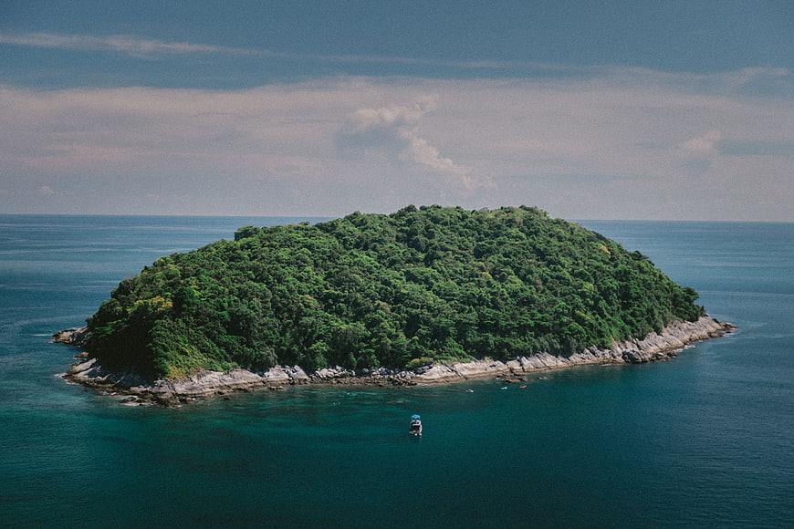 Aerial View of Lush Green Island in Blue Ocean