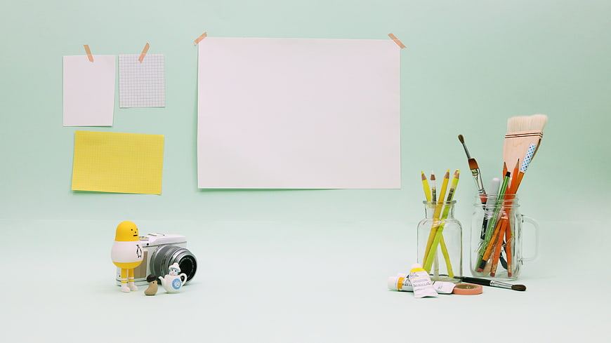 Minimalist pastel workspace with art supplies and copyspace