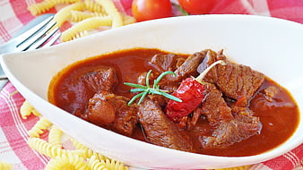 Hearty Beef Goulash with Pasta on Red Checkered Tablecloth