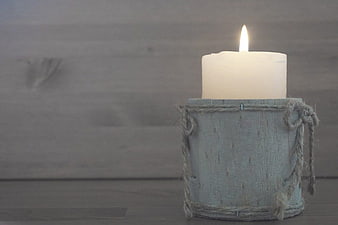 Rustic Lit Candle in Wooden Holder on Gray Background
