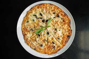 Homemade Margherita Pizza With Black Olives And Fresh Basil On White Plate