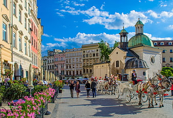 Horse-drawn carriage on cobblestone street in Krakow, Poland