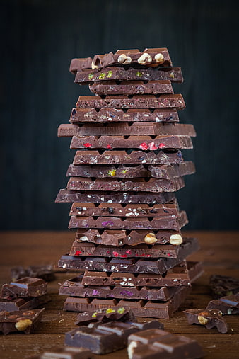 Stack of assorted chocolate bars with nuts and dried fruit