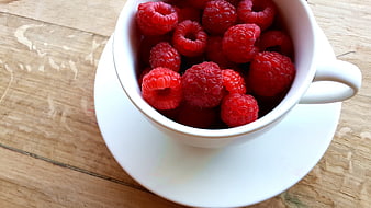 Fresh Raspberries in White Cup on Wooden Table