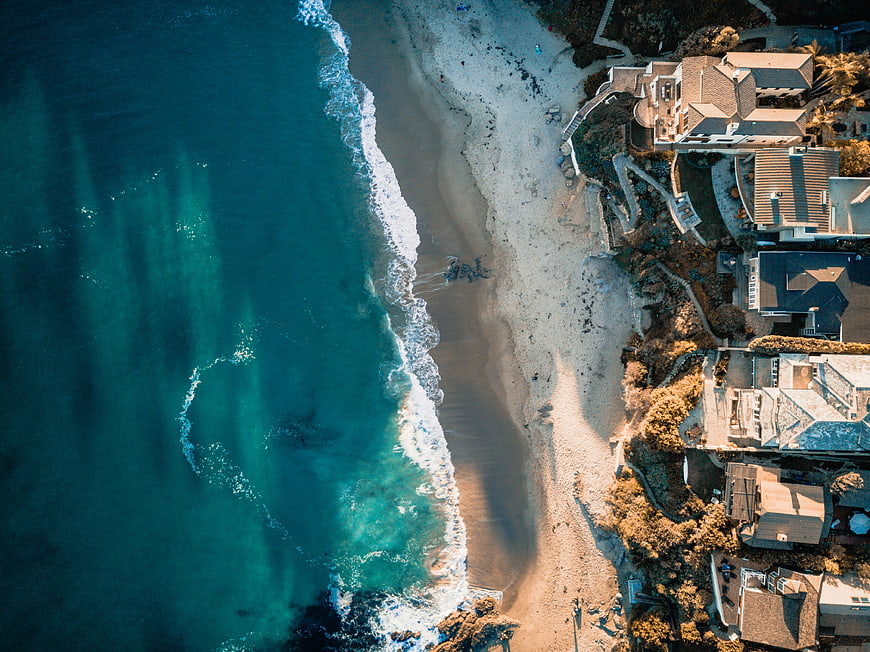 Aerial View of Turquoise Ocean Waves Crashing on Sandy Beach