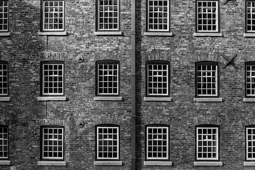 Symmetrical Black and White Brick Building Facade with Windows
