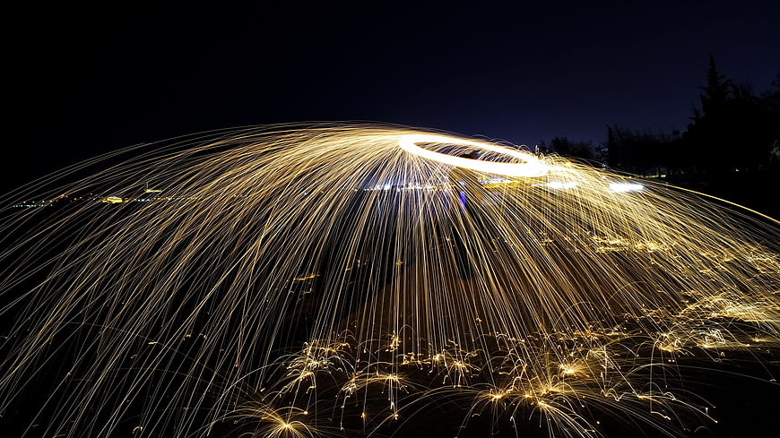 Steel wool sparks creating a glowing dome at night