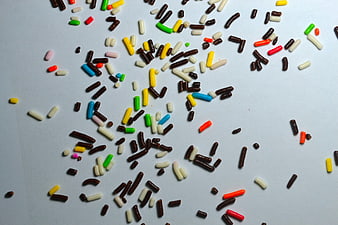 Colorful Chocolate Sprinkles Scattered On Light Blue Background