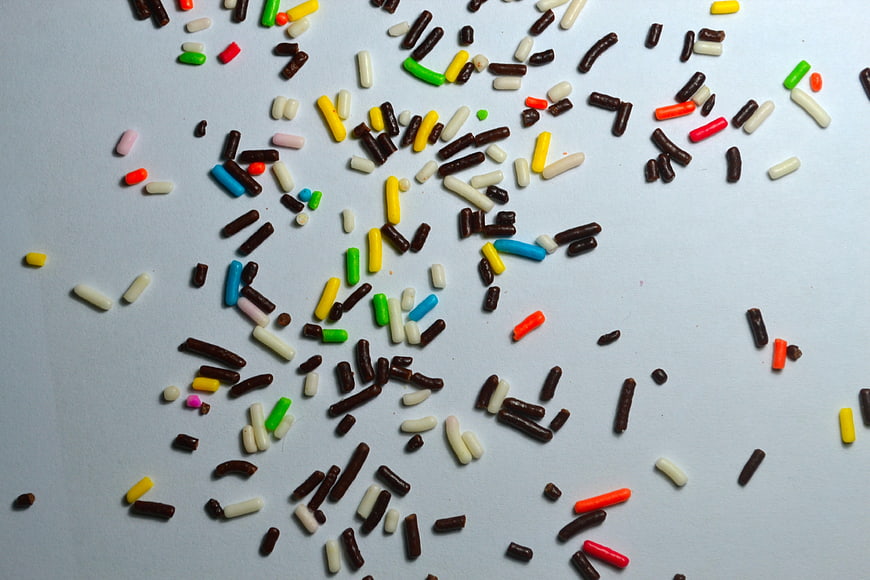 Colorful Chocolate Sprinkles Scattered On Light Blue Background