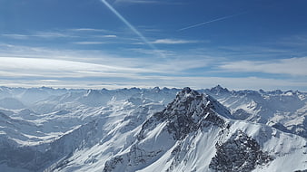 Snowy Alpine Mountain Peak Panorama with Blue Sky