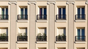 Symmetrical Beige Apartment Building Facade with Balconies