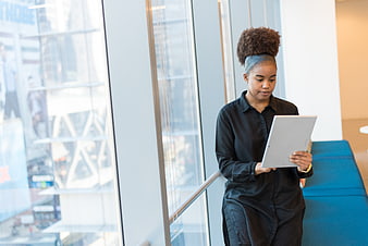 African American woman using tablet in modern office
