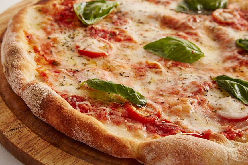 Fresh Margherita Pizza with Basil on Wooden Board