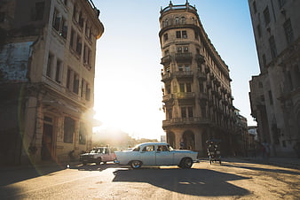Vintage White Classic Car Driving on Havana Street