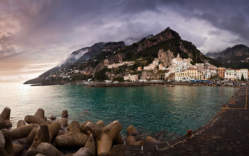 Dramatic coastal town on steep cliffs overlooking turquoise sea