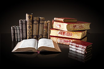 Vintage Books Collection on Dark Reflective Surface